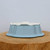 Underside of the light blue glazed ceramic bonsai pot