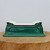 Side view of the emerald green glazed pot on a circular wood block