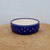 Shallow round pot with a deep blue exterior and cream interior