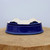Underside of the shallow oval bonsai pot on a natural wood block