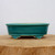 Front view of the glossy teal-green glazed bonsai pot