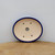 Top-down view of the oval pot with a glossy dark blue rim