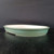 Shallow sea green oval pot with a white interior, seen edge on