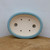 Top-down angled view of the shallow oval light blue glazed pot