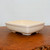 Three quarter side view of the cream glazed rectangular pot