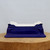 Cobalt blue glazed rectangular pot on a light brown wood slice