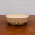 Shallow cream oval bonsai pot on a rustic wooden surface