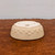 Underside of the cream glazed round ceramic bonsai pot