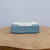 Five inch light blue glazed pot on a rustic natural wood slab