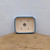 Light blue glazed rectangular pot standing upright on a wooden slab