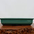 Low angle profile of the shallow pot in deep teal-green