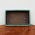 Top-down view of the shallow rectangular pot on textured wood