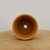 Top-down view of the small round unglazed ochre pot
