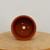 Overhead view into the round unglazed terracotta bonsai pot