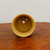 Top-down view into the unglazed light yellow ceramic pot