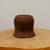 Unglazed ceramic pot in a rich reddish brown terracotta