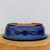 Underside of the Yixing bonsai pot on a natural wood block