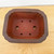 Top-down view of the 4 inch unglazed Yixing pot in matte reddish brown
