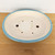 Top-down angled view of the 12 inch oval Yixing pot on light brown wood