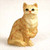 A detailed figurine of a red shorthaired tabby cat sitting in a classic, alert pose with its right front paw slightly raised. The cat features a warm ginger-colored coat with distinct, darker orange tabby stripes along its back and sides. Its chest, throat, and face are painted in a soft cream-to-white color, framing large, dark, lifelike eyes and a small, delicate pink nose. The figurine is crafted with a fine, textured finish that mimics the appearance of short fur. Set against a plain, light-colored background, this charming cat figurine is designed as a miniature decorative accessory, perfect for adding a touch of personality to a bonsai arrangement or shelf display.