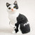 Miniature black and white Manx cat figurine seated, with a short dense coat texture