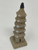 A small, handcrafted ceramic mudman figurine of an ancient five-story Chinese pagoda, designed for use as a bonsai tree decoration. The miniature tower is made from a light-colored, sandy-beige clay with a rustic, unglazed texture. It features five distinct levels, each with a flared, ribbed roof adorned with small, pointed white accents at the corners. The base includes a small arched entryway, and each subsequent story has a tiny circular window. The entire structure stands on a square, tiered base and is topped with a dark, almost black, rounded finial. This traditional Chinese-style figurine is intended to add character and a sense of ancient history to a miniature bonsai landscape or terrarium.
