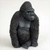 A highly detailed miniature gorilla figurine designed for bonsai tree or terrarium decoration. The small, dark gray statue features an intricate texture to mimic fur and depicts the gorilla in a calm, seated pose with its head turned slightly to the side. The figurine is shown against a plain white background, highlighting its realistic features and suitability as a playful accessory for miniature indoor gardens.