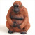 A detailed miniature figurine of a sitting orangutan, designed as a bonsai tree accessory. The small sculpture is crafted with a reddish-orange textured finish to resemble thick fur, with a dark black face, hands, and feet. The orangutan is hunched over in a naturalistic pose with its hands resting on its large belly, set against a clean white background.