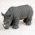 Miniature rhinoceros figurine in charcoal grey with a wrinkled skin texture