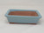 A detailed studio photograph of a 5-inch rectangular light blue glazed Yixing bonsai pot (model YX1130C) against a plain, off-white background. The pot features a soft, powder-blue glossy glaze with subtle speckling that covers the exterior sides and the flat, overhanging rim. The interior and the bottom edge of the pot are unglazed, revealing the natural, warm reddish-brown tone of the Yixing clay. The pot has a classic rectangular shape with slightly tapered sides and sits on four small, integrated feet designed to provide essential drainage and airflow for a bonsai tree's root system.