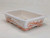 A rectangular, white-glazed Yixing bonsai pot with a classic, hand-painted design. The pot features a shallow rectangular shape with a flared rim and four decorative feet. The sides are adorned with traditional landscape scenes in a warm, monochromatic terracotta red, depicting serene pagodas, rolling mountains, and delicate trees in a fine line-art style. Each landscape is enclosed within a hand-drawn, ornamental frame. The top rim is decorated with a thin, repeating vine-like pattern, while the four feet are finished with a cross-hatched lattice design in the same reddish-brown color. This elegant ceramic pot is shown from a three-quarter perspective, highlighting its detailed artwork and smooth, glossy finish against a neutral, off-white background.
