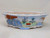 Shallow oval white pot with a hand-painted landscape and scalloped rim