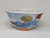 Close-up of the intricate landscape painted on the cream glazed pot