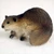 Miniature beaver figurine in a crouched pose, a decorative bonsai accessory