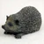 Miniature hedgehog figurine in a low crawling stance, a bonsai accessory