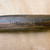 Close-up of the tinyroots brand engraved on a dark wood tool handle