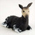 Miniature okapi figurine lying at rest, with dark brown and striped markings