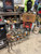 Dozens of handcrafted robot sculptures on a concrete workshop floor