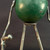 Close-up of a weathered green vintage croquet ball used as a robot body
