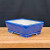 Rectangular pot in a vibrant glossy cobalt blue on a wooden shelf