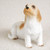 Miniature Petit Basset Griffon Vendeen figurine in a seated pose