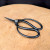 Kaneshin 40J butterfly root shears resting on a light tan circular surface