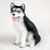 Miniature black and white Siberian Husky figurine with blue eyes, seated