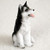 Miniature black and white Siberian Husky figurine with brown eyes, seated