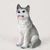 Miniature gray and white Siberian Husky figurine with brown eyes, sitting upright