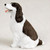Miniature liver and white English Springer Spaniel figurine in a sitting position