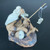 Handcrafted clay figurine of an elderly Chinese fisherman on a rocky base