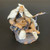 Chinese mud man figurine of an elderly fisherman seated on a dark textured rock, F-002