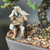 Close-up of the clay fisherman mud man figurine on a dark rock