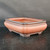 10 inch unglazed rectangular Yixing pot on a dark wooden surface